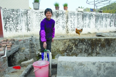 曹坑村村民叶满招拧开自家门口的水龙头说,村里的自来水水质很好,够用